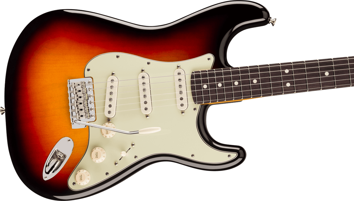 Angled view of the 3-Color Sunburst Stratocaster body: master volume and two tone knobs, five-way blade switch, aged-white pickup covers and the chrome six-saddle tremolo