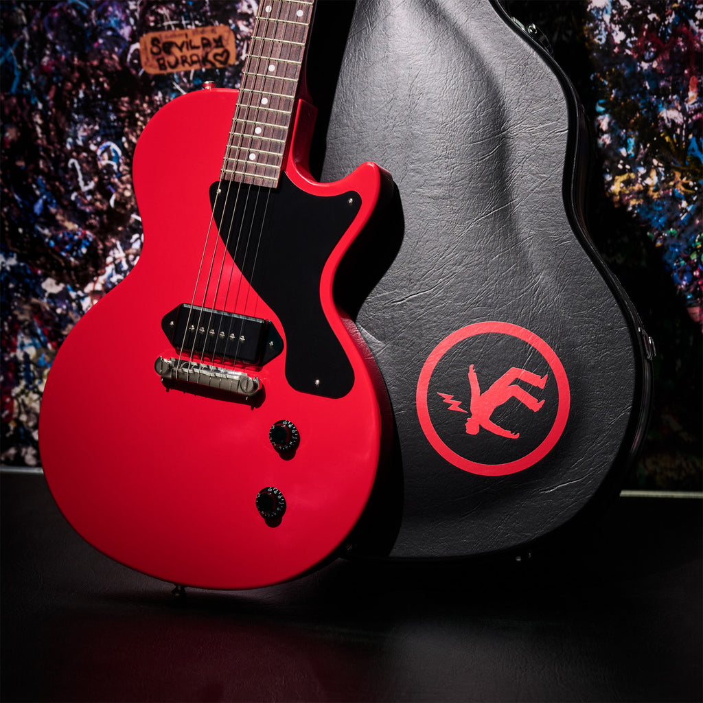 Included hardshell case alongside the Radiant Red Les Paul Junior