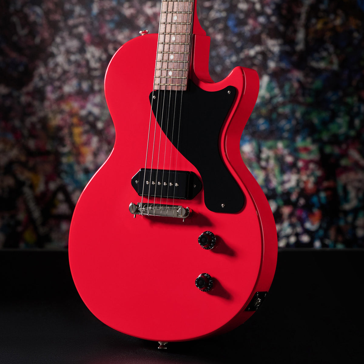 Radiant Red Les Paul Junior against a graffiti backdrop