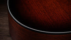 Black binding meeting the satin mahogany top on the lower bout edge