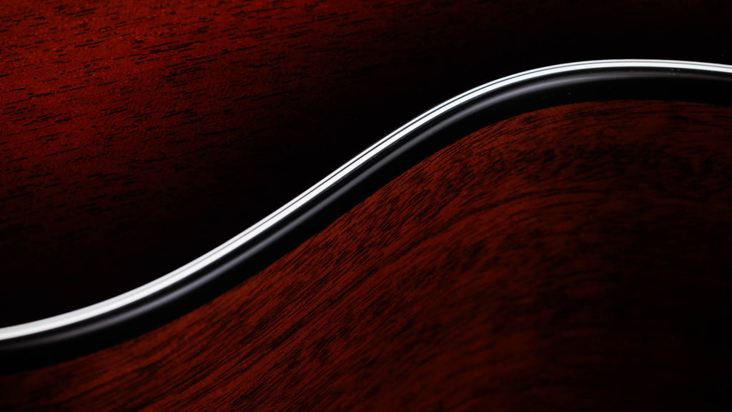 Close detail of the mahogany grain and black binding on the Taylor 322ce