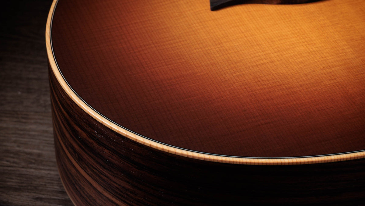 Close detail of the matte sunburst top edge, binding and spruce grain