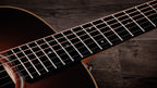 Ebony fingerboard with dot inlays running the length of the neck