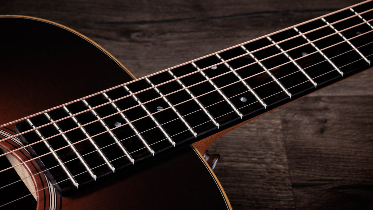 Ebony fingerboard with dot inlays running the length of the neck