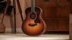 Taylor GS Mini-e Rosewood SB standing in a room, showing the full sunburst body