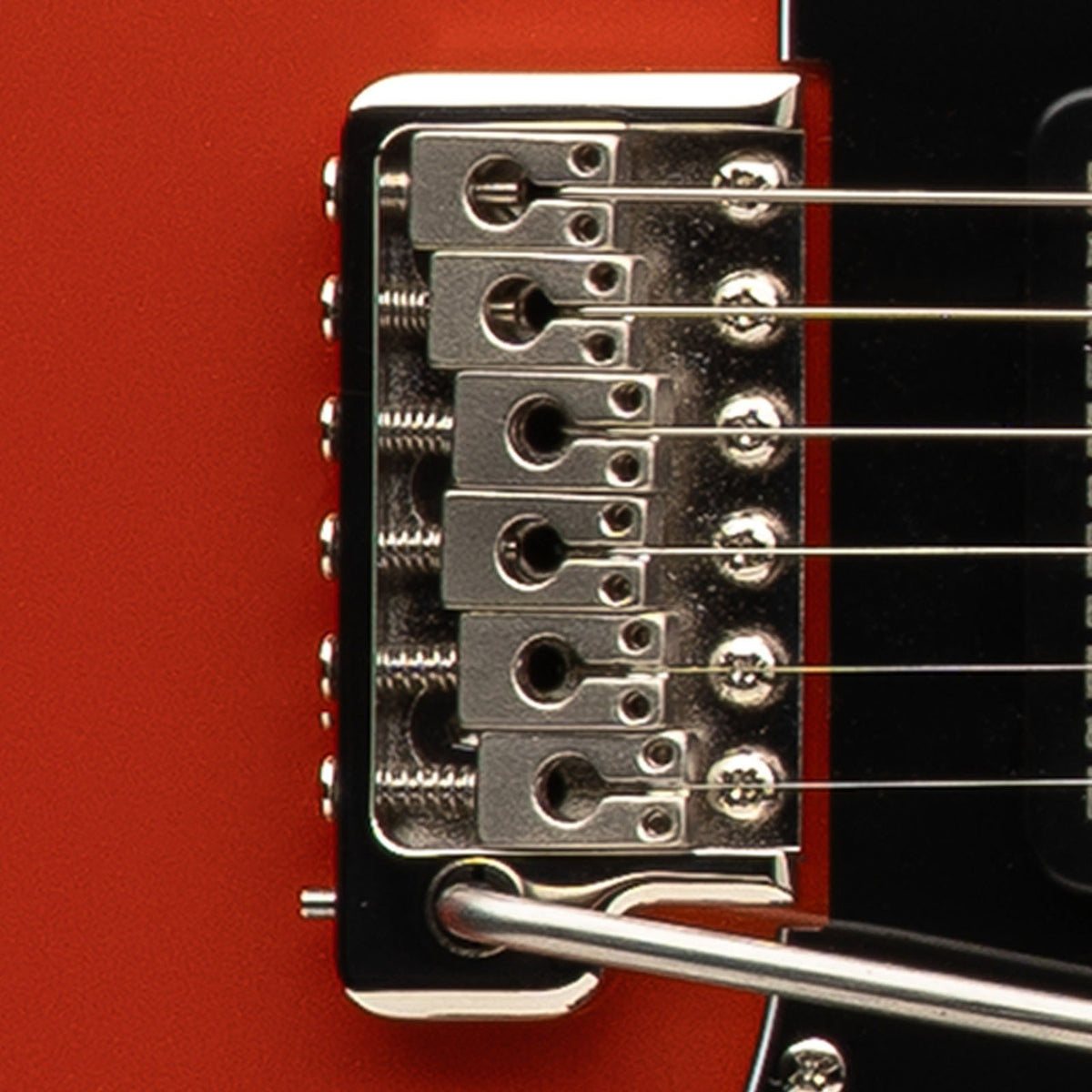 PRS patented tremolo on the SE NF3, close-up against the Metallic Orange body