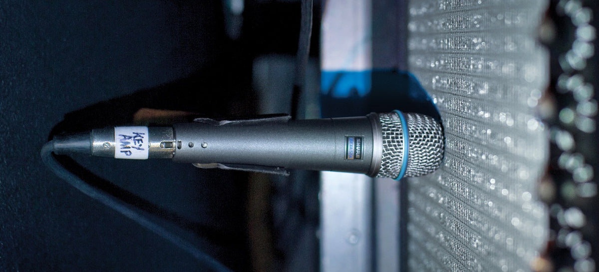 Shure Beta 57A close-miking a guitar amplifier speaker on stage
