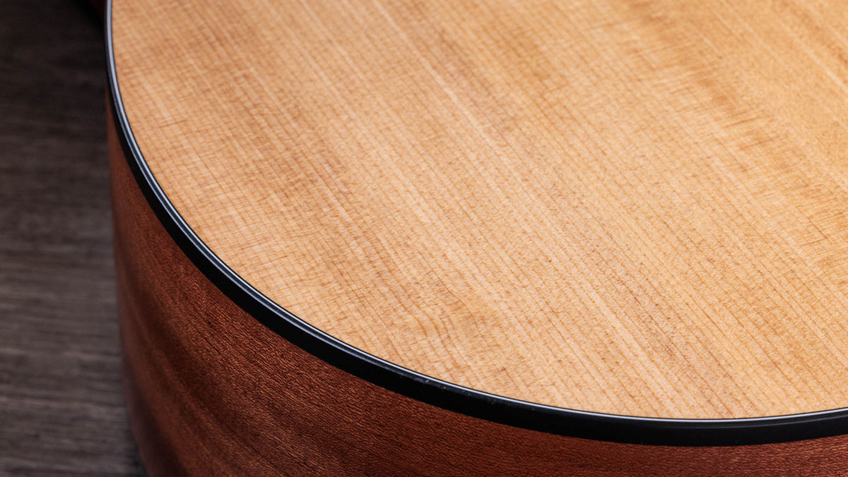 Black binding meeting the torrefied spruce top on the lower bout edge